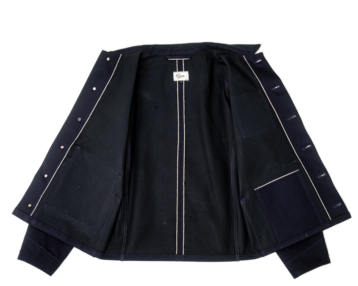 Black jacket with white piping on a white background